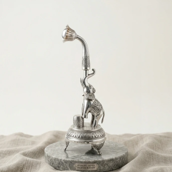 925 Sterling silver elephant incense burner holder with curved lotus diffuser stem on a marble display base.