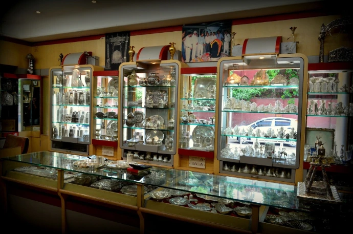 Silverware showcase, pure silver idols display, luxury silver store gallery, silver mandir accessories showroom